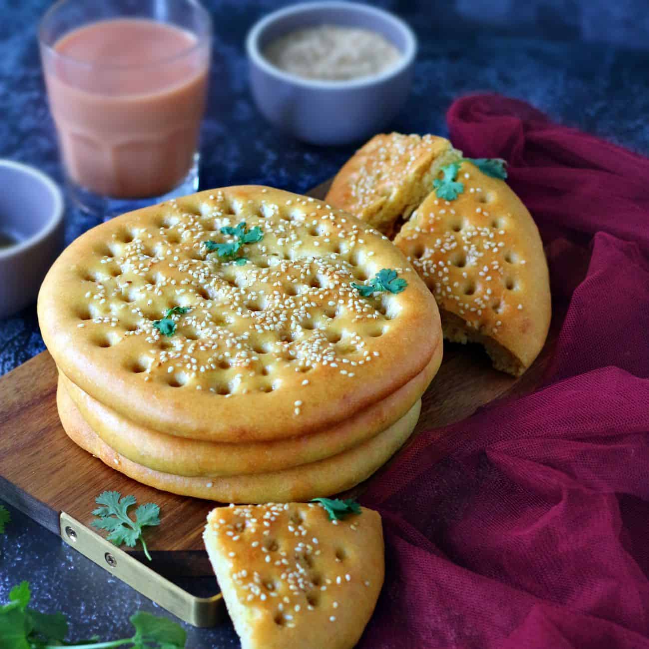 Stack of Roghni Naan on a wooden serving board