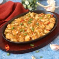 Chinese Chicken in Garlic Sauce in a cast iron serving dish.