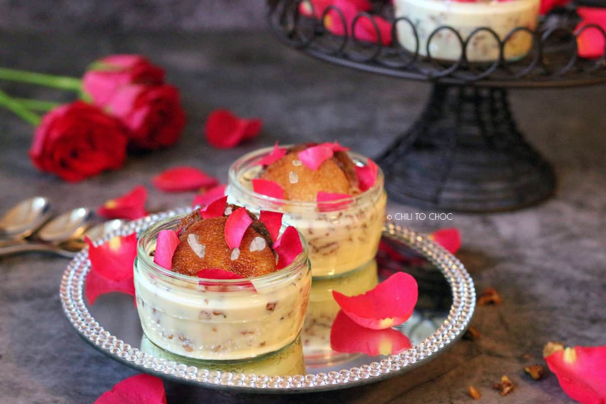 Bread pudding in mini jars on a glass plate.