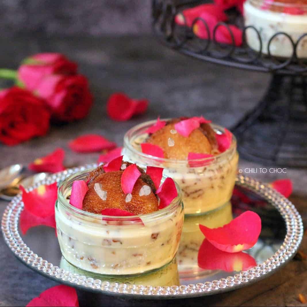 Two pots of shahi tukray on a decorative glass plate.