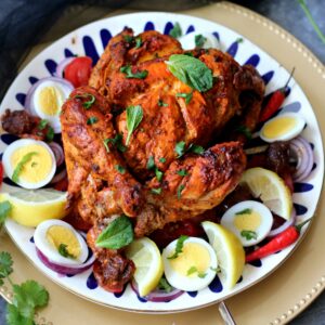 Murgh Musallam surrounded by sliced hard boiled eggs
