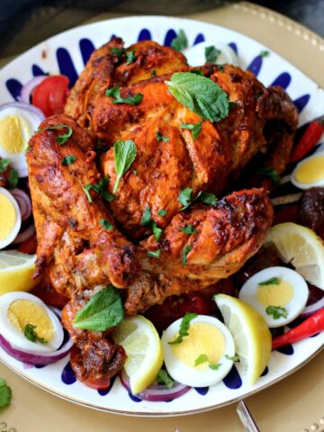 Murgh Musallam surrounded by sliced hard boiled eggs