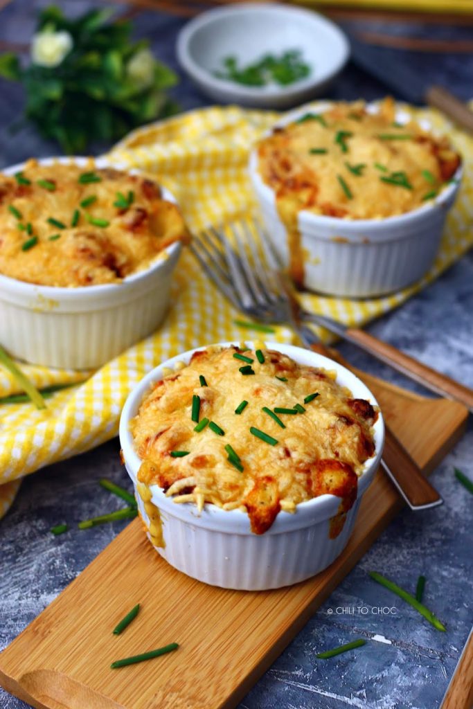 Mac and cheese garnished with chives served in ramekins