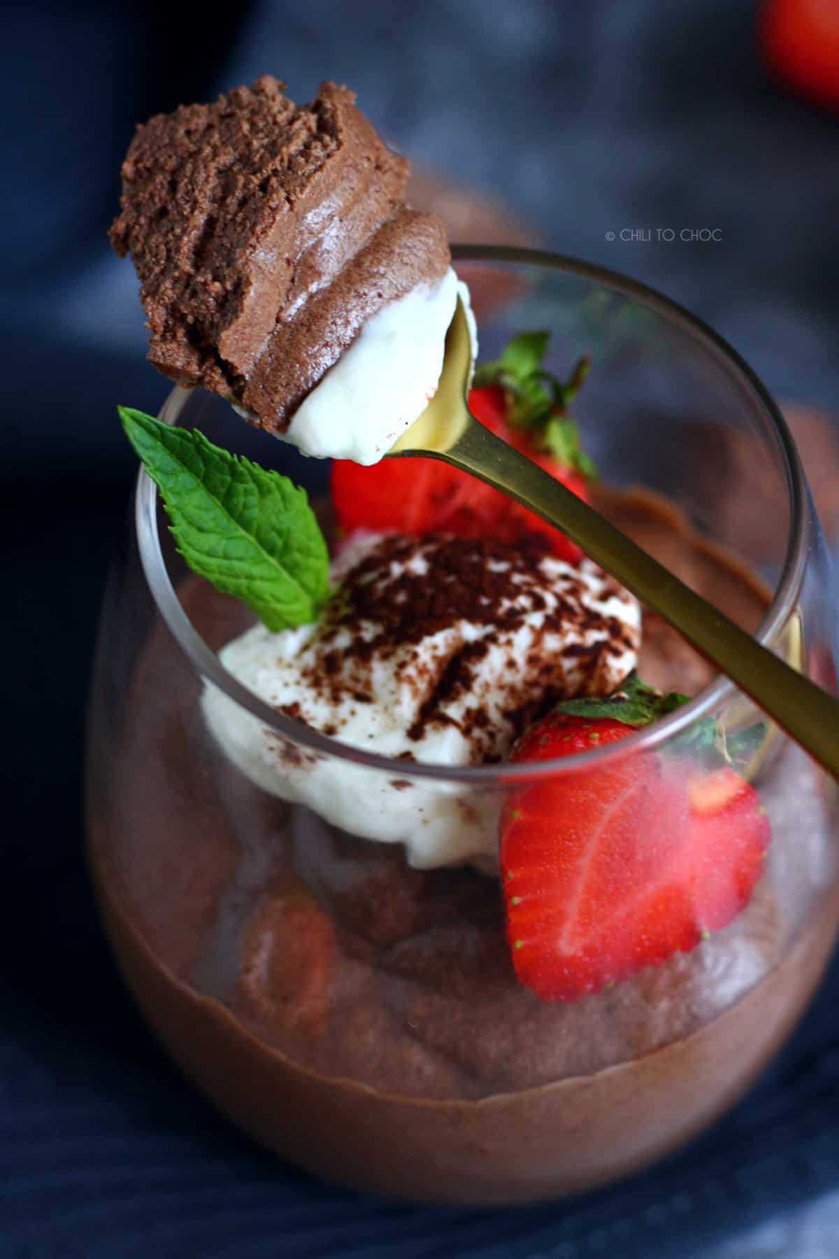 Chocolate Mousse in a glass with strawberries, mint and whipped cream