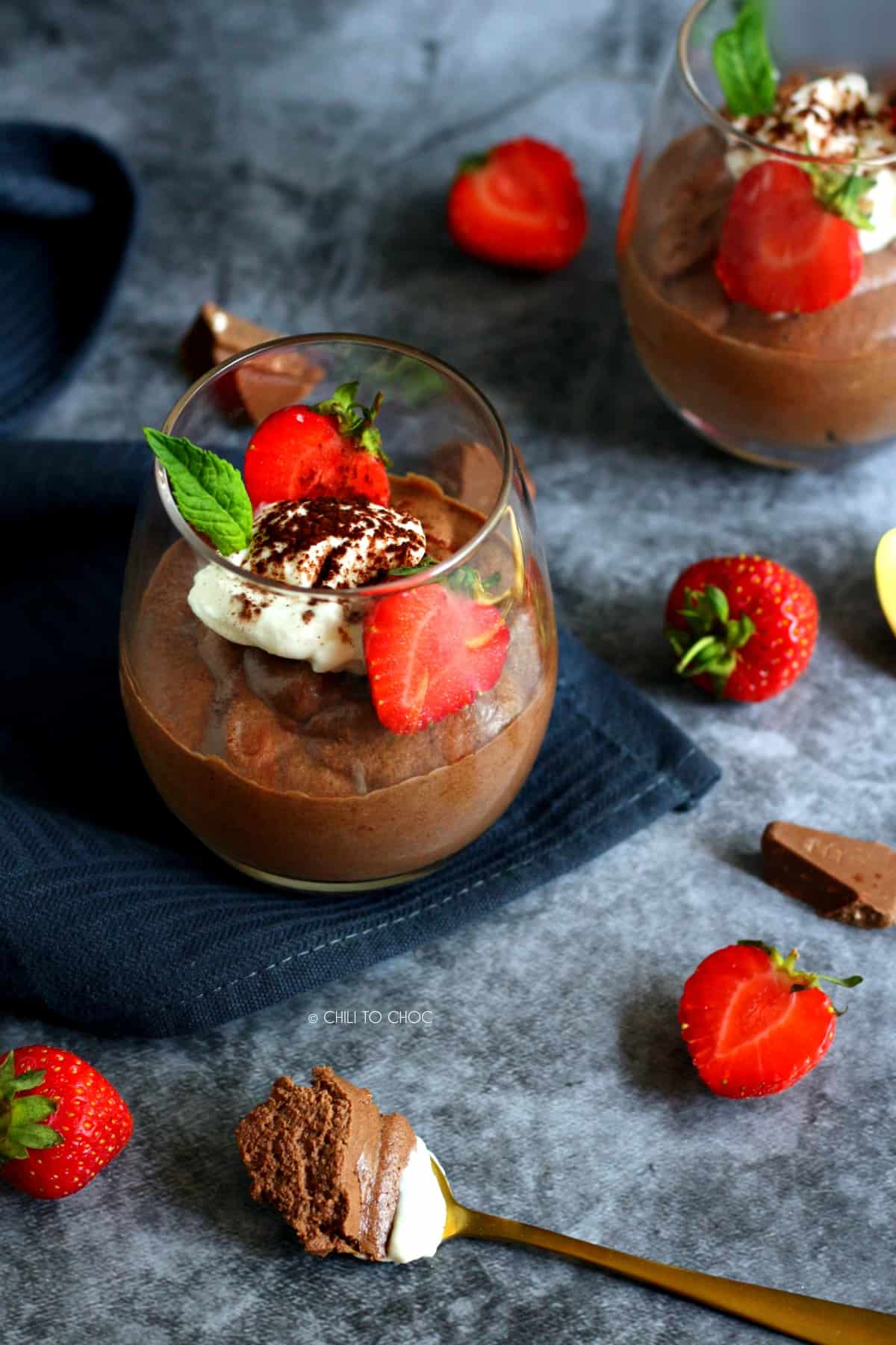 Chocolate Mousse in a glass with strawberries, mint and whipped cream