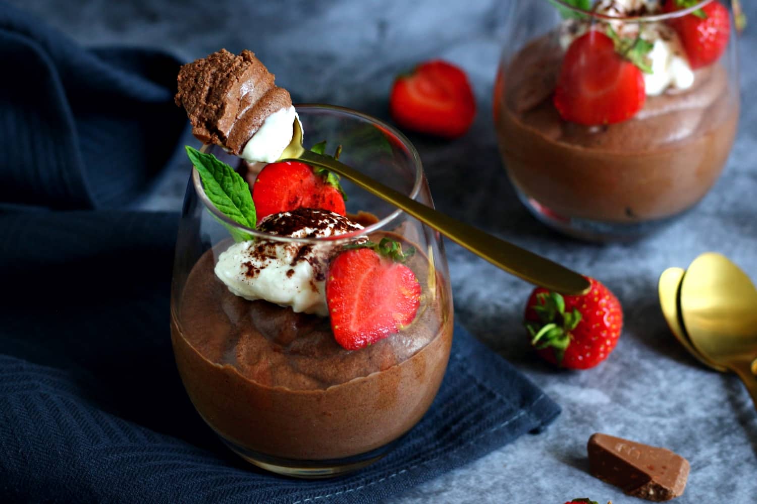 Chocolate Mousse in a glass with strawberries, mint and whipped cream