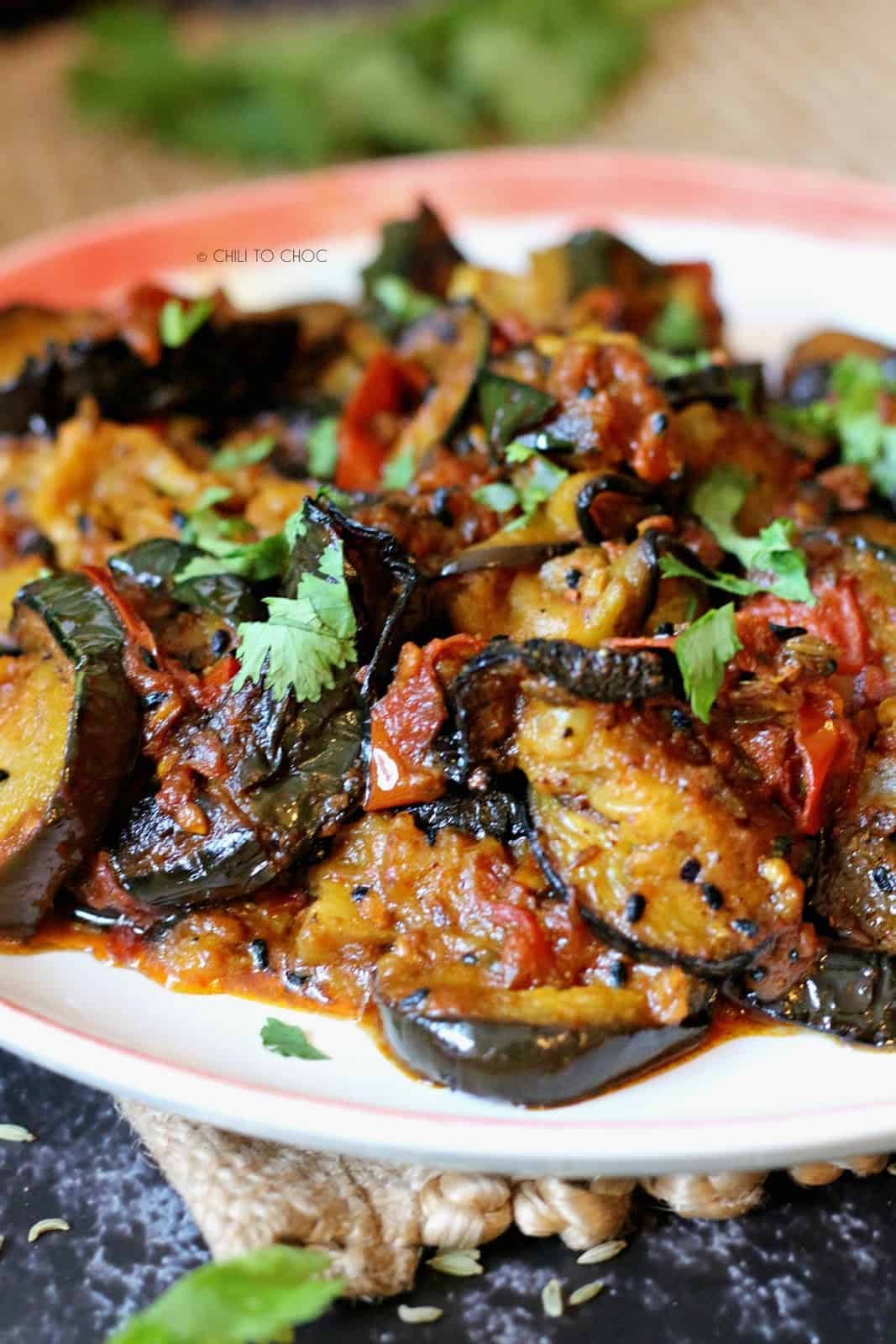 Closeup of a plate of achari baingan,