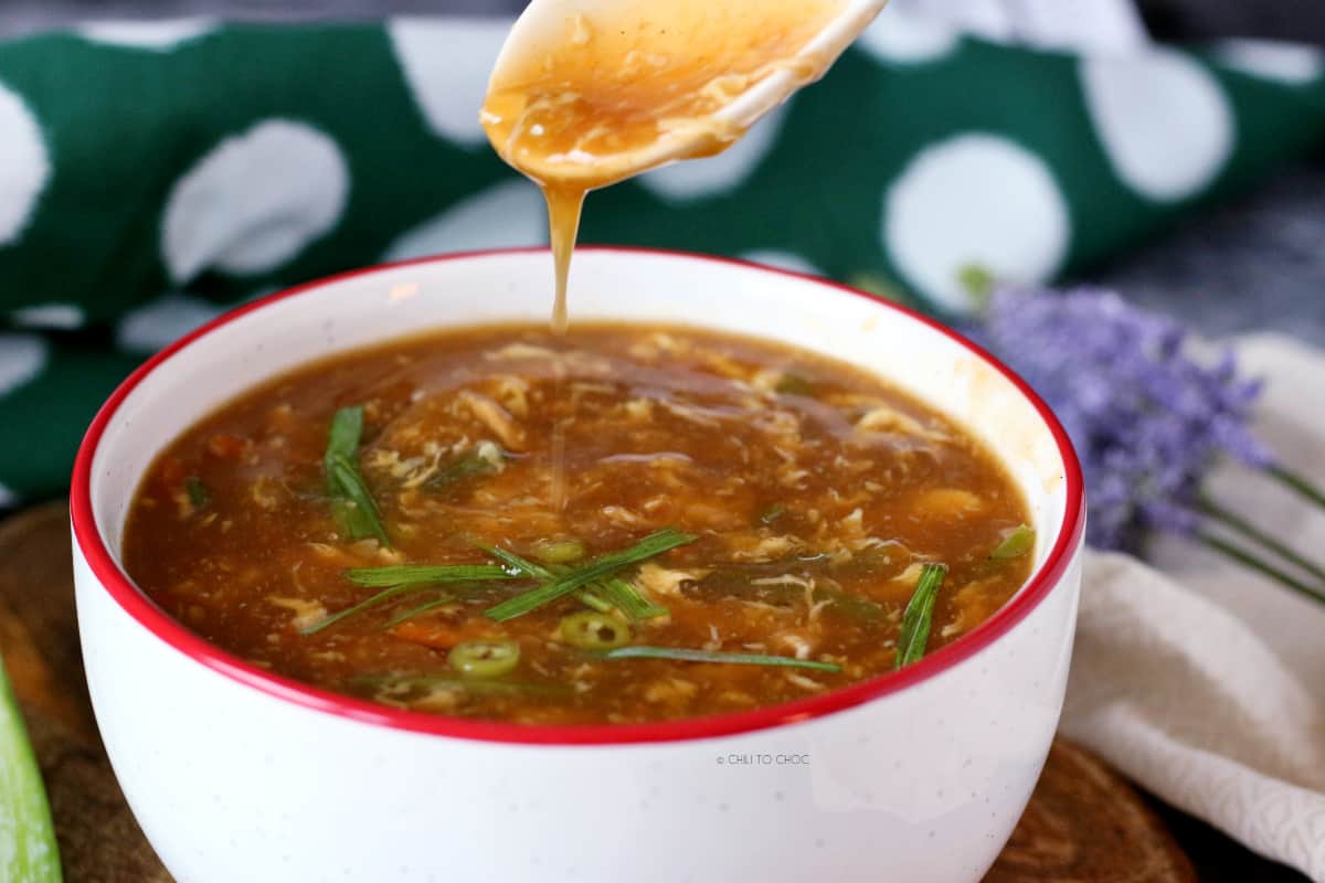 pouring shot of hot and sour soup