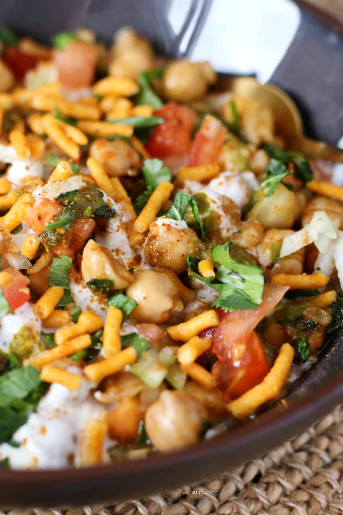 Boiled chickpeas with diced tomato, sev, yogurt and fresh coriander