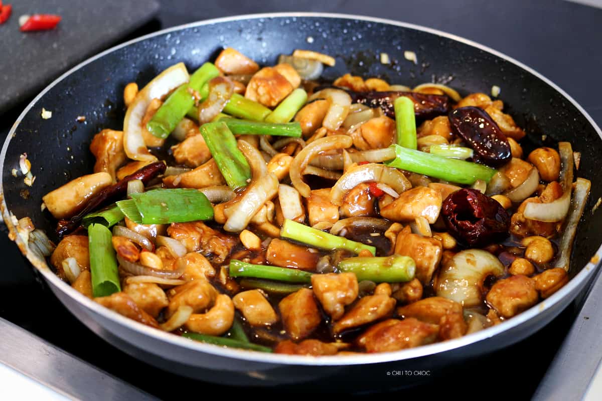 Thai Cashew Nut Chicken Cashew Chicken Stir Fry cooking in a frying pan.