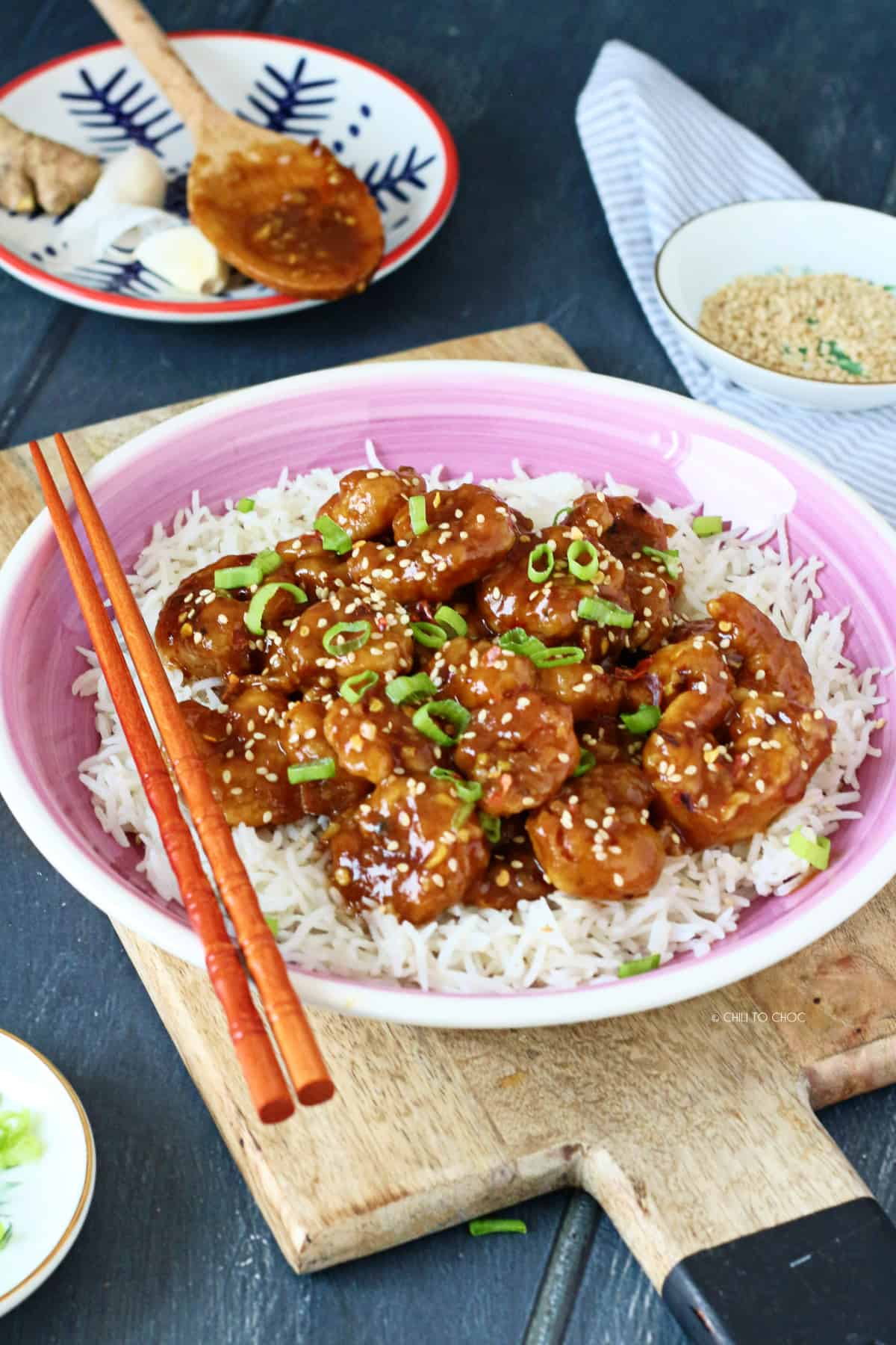 General Tso's Shrimp on white rice garnished with sesame seeds and spring onion