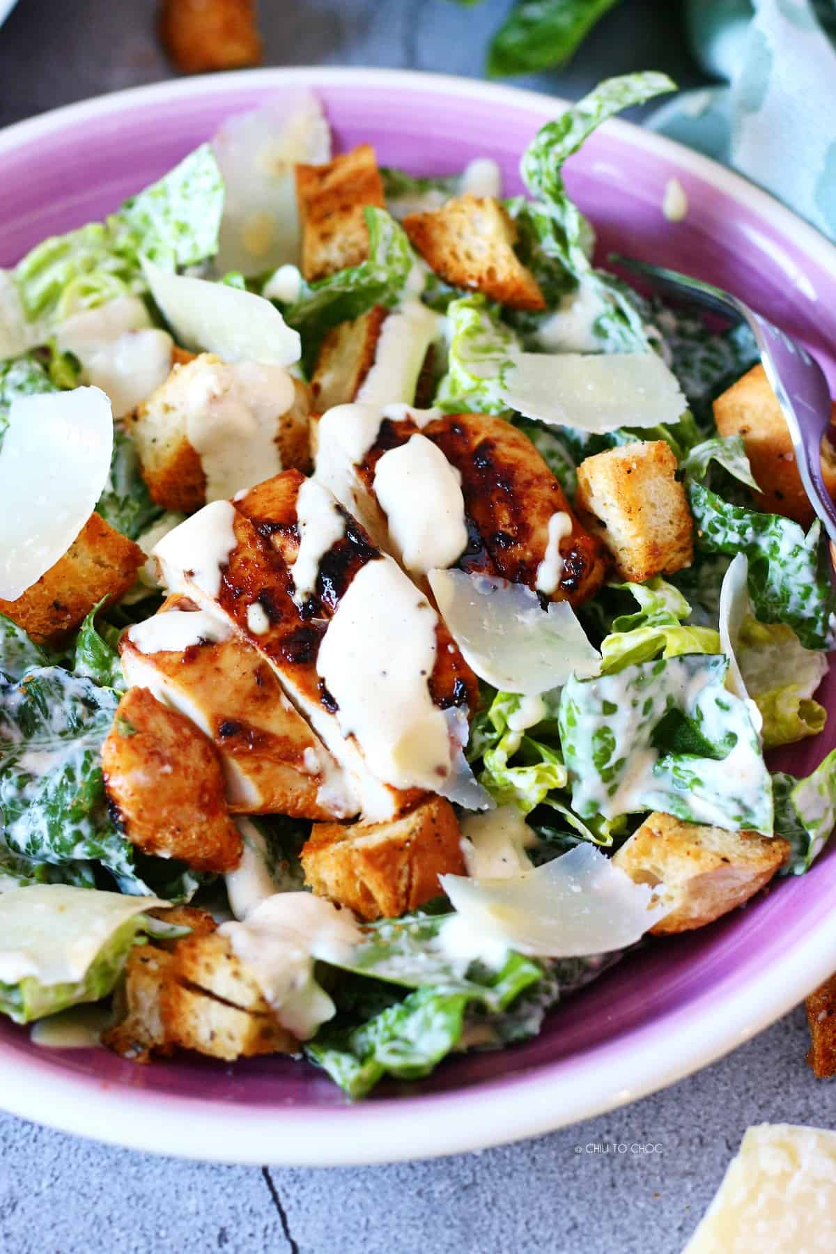 Caesar salad with grilled chicken, dressing, croutons and Parmesan cheese.