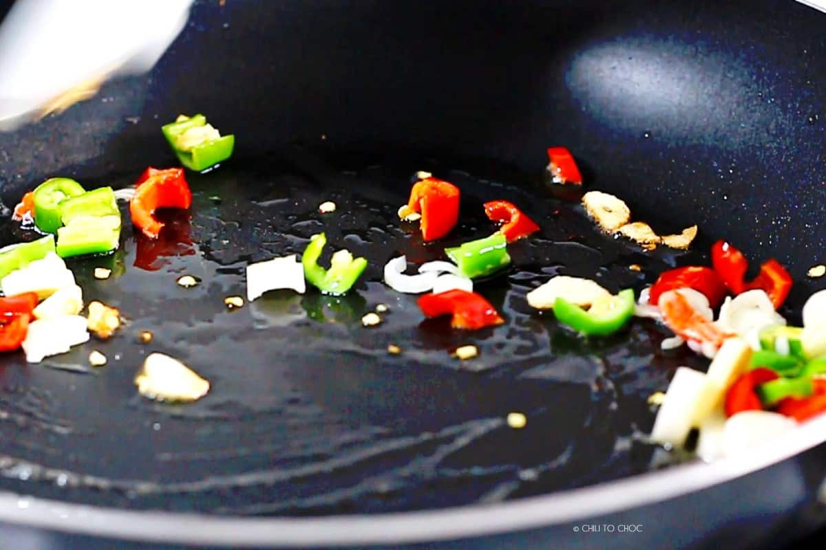 Stir frying aromatics in pan.