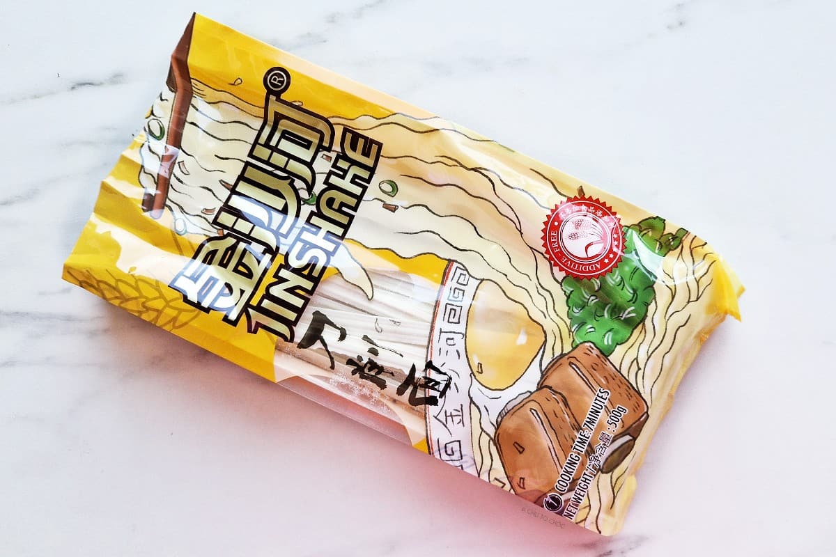 Package of wide wheat noodles.