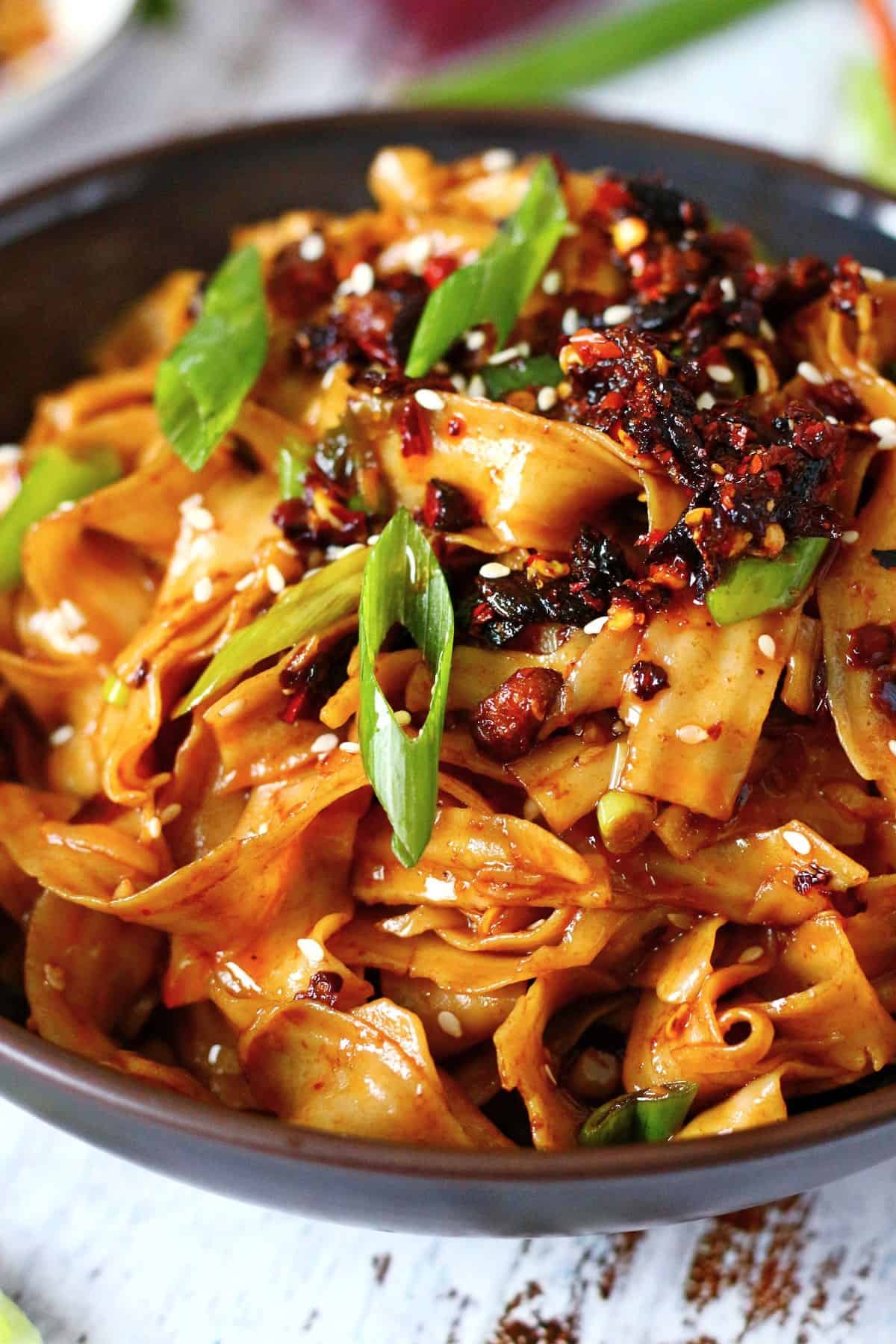 Wide noodles topped with chili crisp.