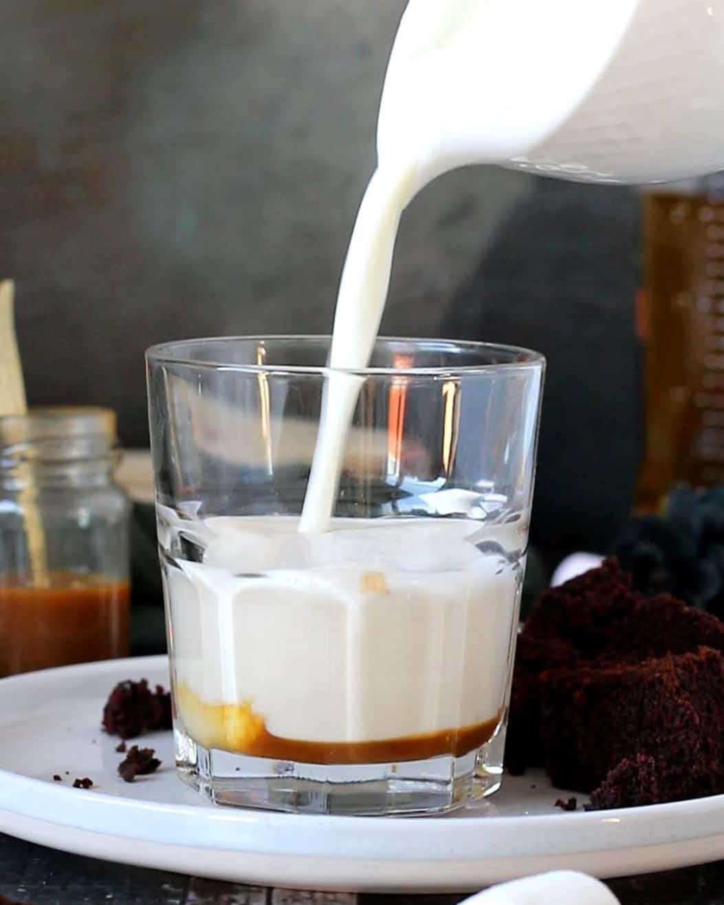 Pouring foamed milk in a glass.