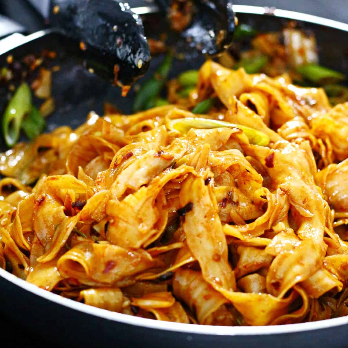 Noodles tossed in the sauce.