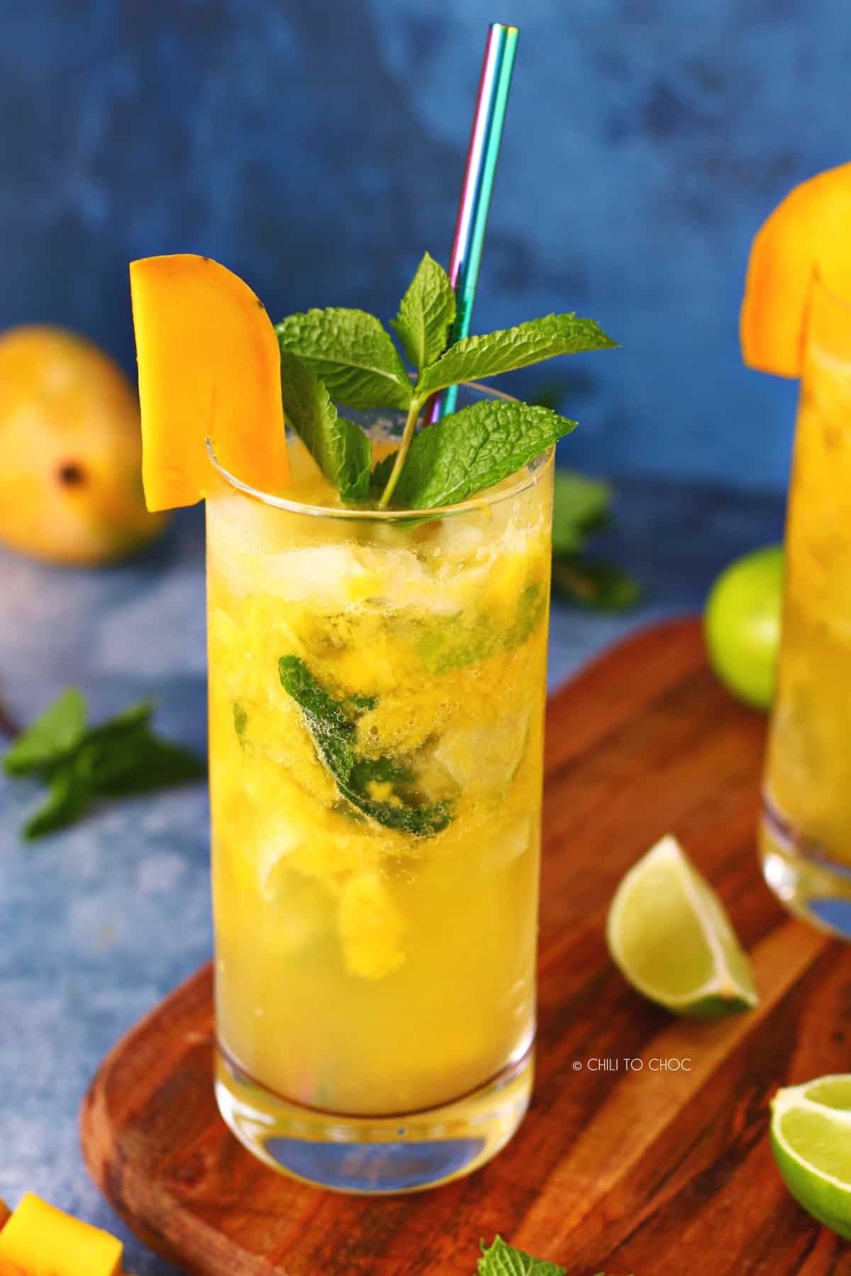 Virgin Mango Mojito in a clear glass garnished with mango slice and mint spring.