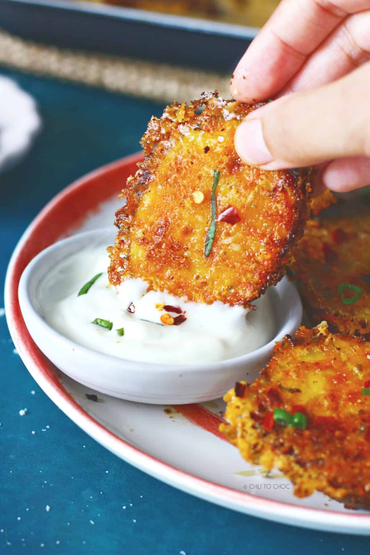 Dipping Parmesan potato in garlic aioli.