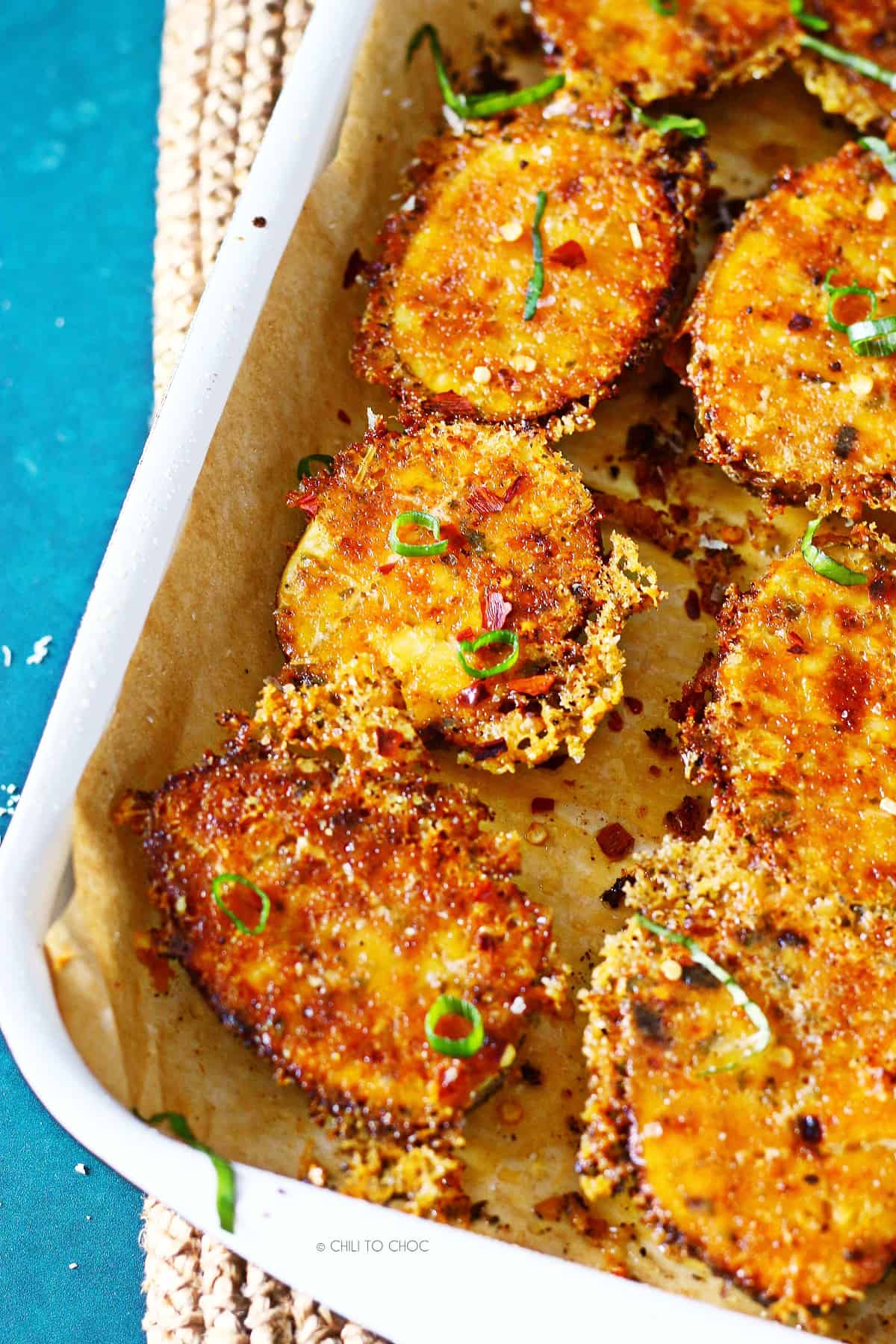 Closeup of freshly baked Parmesan crusted potatoes in a sheet pan.
