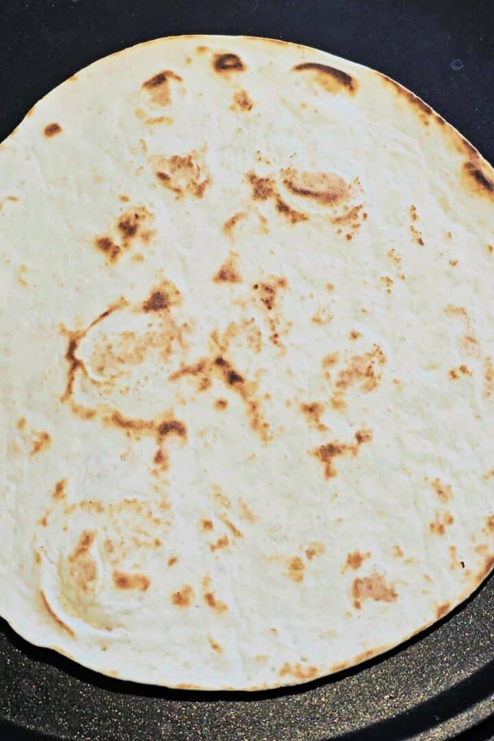 Toasting tortilla in a pan.