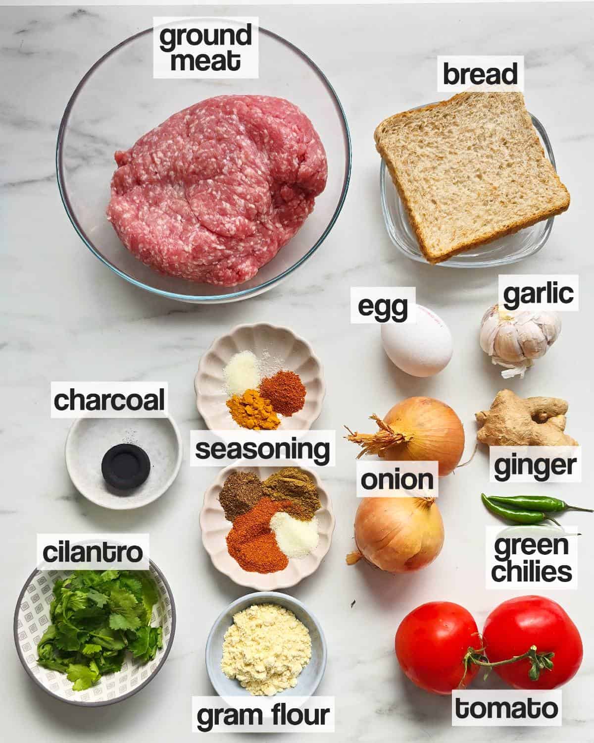Labeled ingredients for kabab masala curry on a plain background.