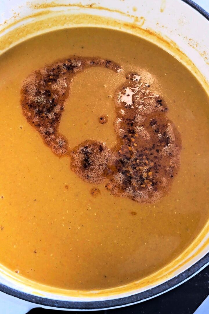 Tempered butter with chili and paprika drizzled over a pot of Turkish red lentil soup.