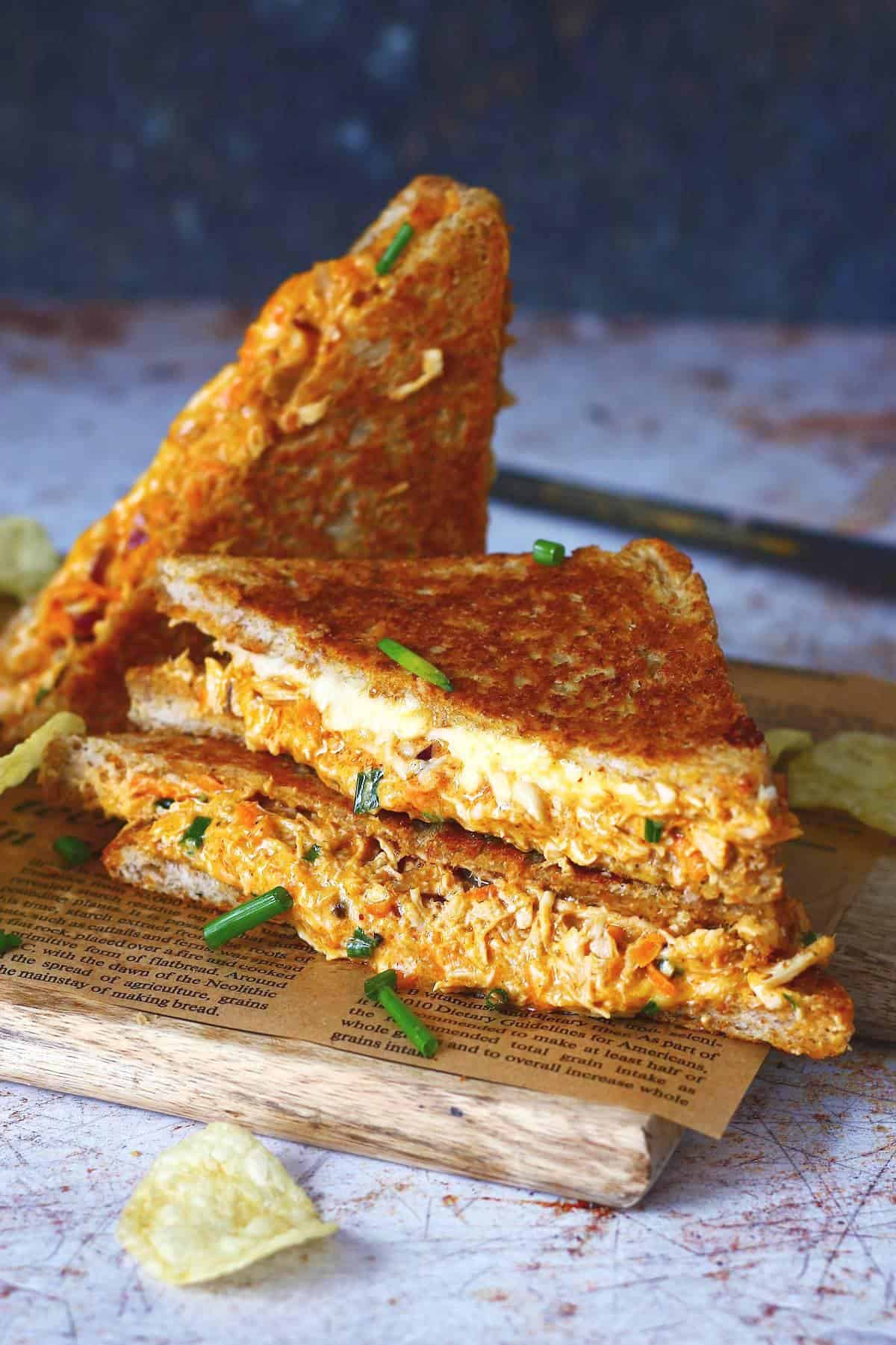 Chicken melt stack garnished with chives.