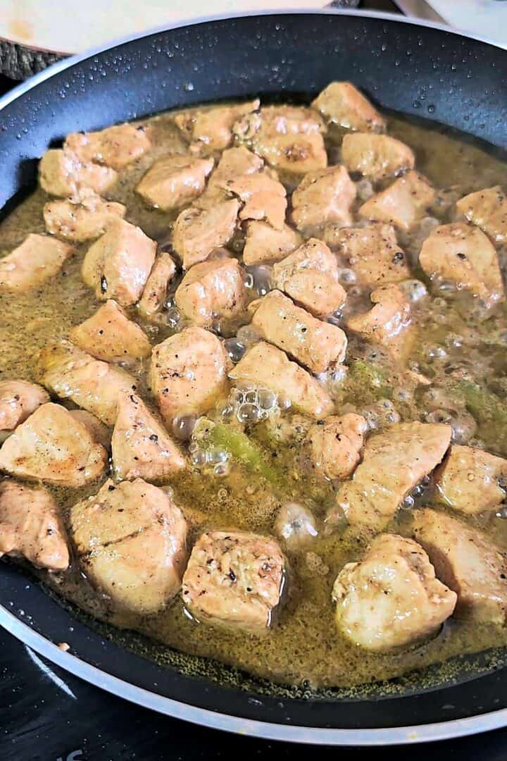 Cooked chicken kali mirch simmering in a creamy black pepper gravy.