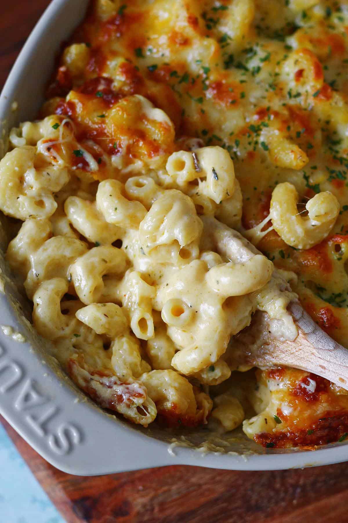 Close-up showing the creamy texture of the cavatappi and the rich cheese sauce underneath the baked, golden-brown topping.