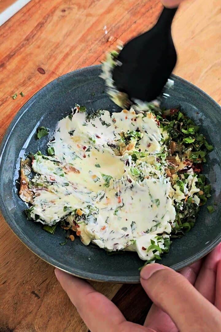 Creamy garlic herb butter mixture in a bowl.