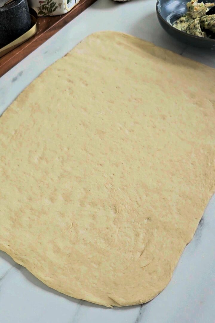 Rolled-out dough on a lightly floured surface.