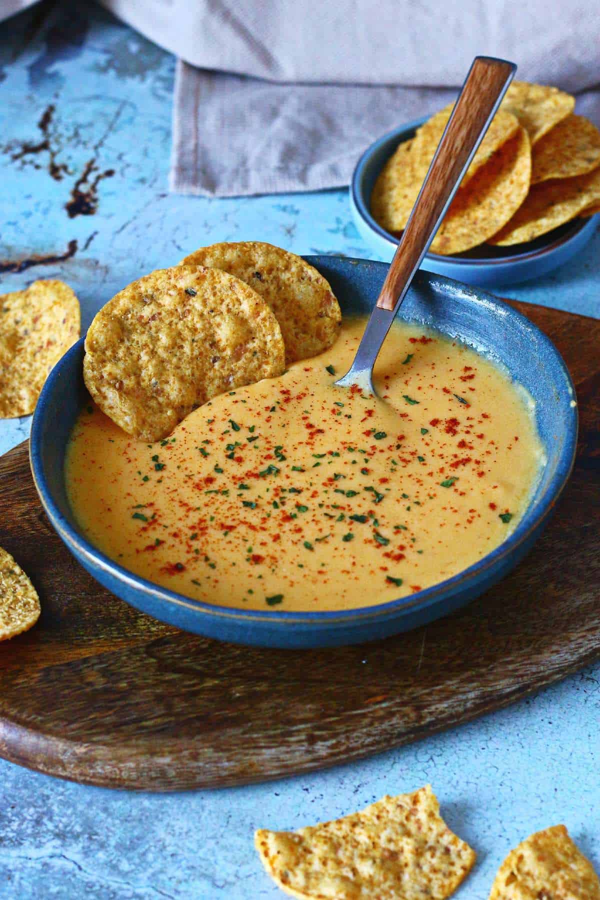 Microwave cheese sauce served in a bowl with tortilla chips for dipping.