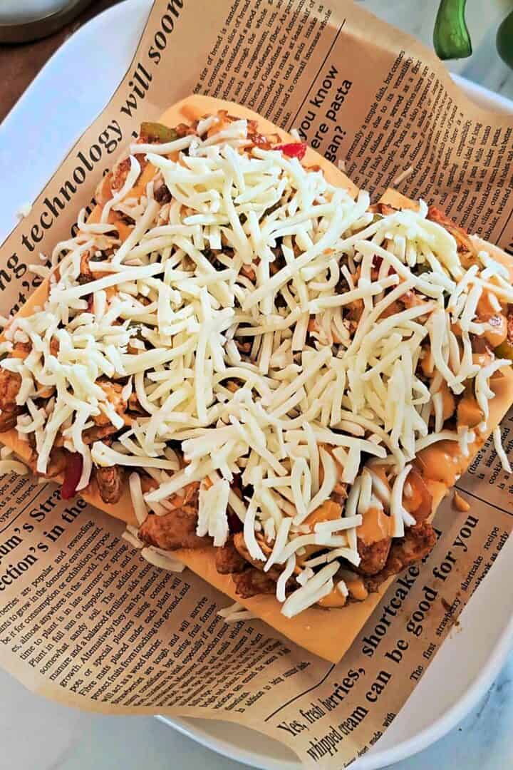 Shredded mozzarella cheese added on top of the chicken filling.