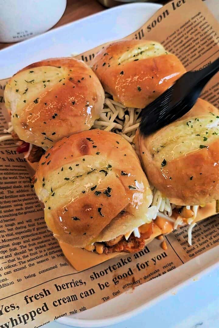 Garlic butter brushed over the tops of the slider buns.