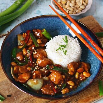 Kung Pao Chicken stir-fry with chicken, peanuts, dried red chilies, and onion in a bold, glossy sauce.