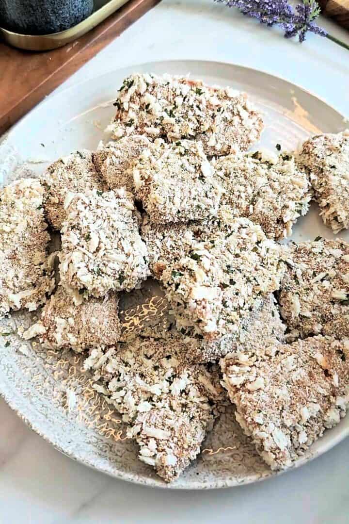 Breaded fish pieces arranged on a plate.
