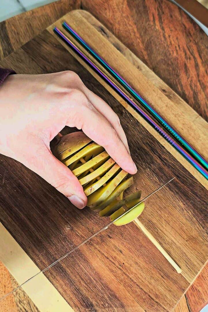 Spiral potato stretched on a skewer after cutting, showing even layered slices.