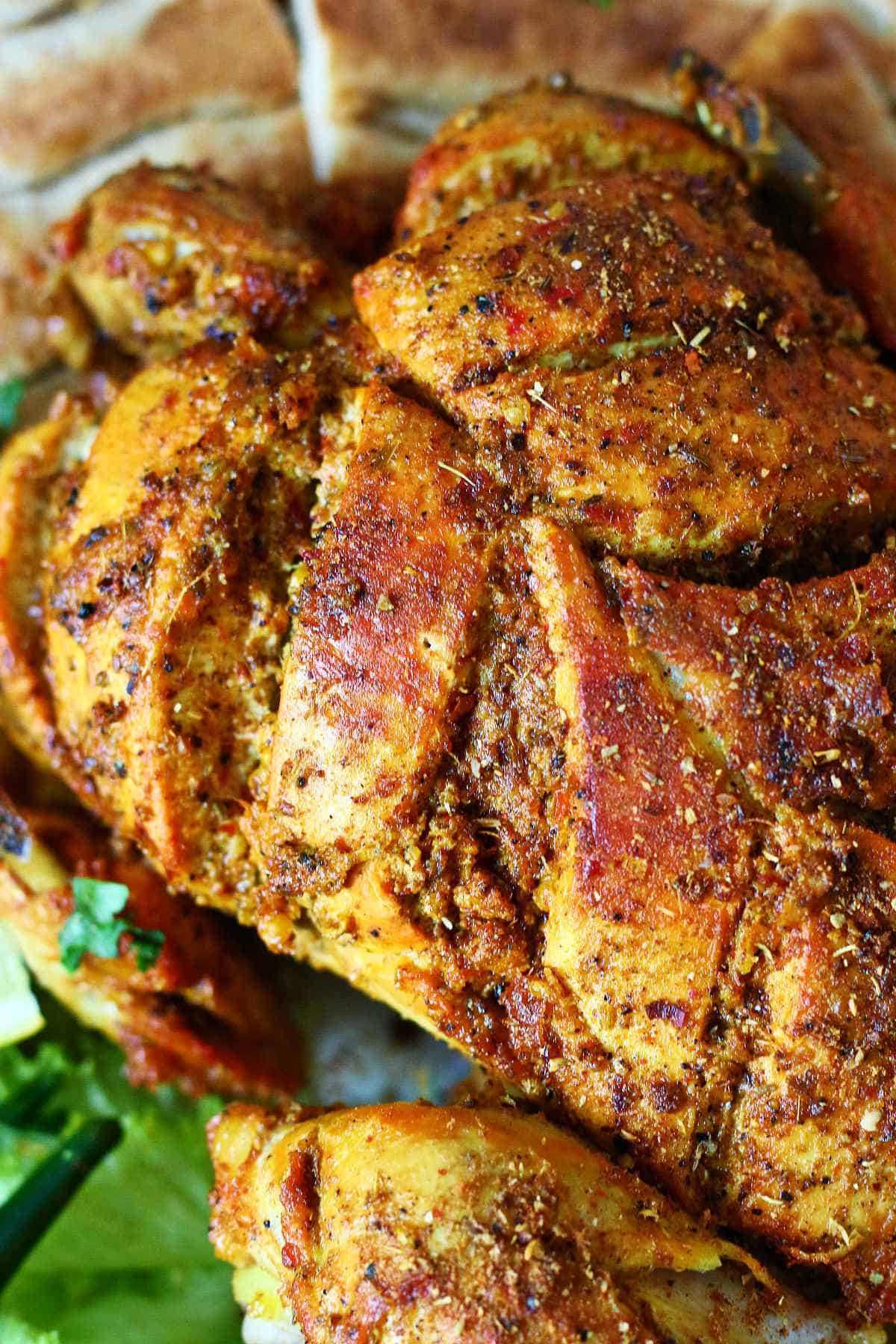 Close up of lahori chicken chargha showing crispy spiced coating and texture.