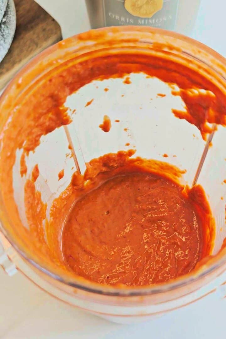 Homemade peri peri sauce blended until smooth in a blender cup.