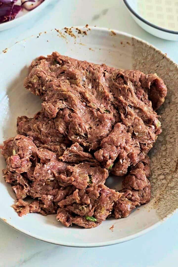 Seasoned gola kabab mixture resting in a bowl before shaping.