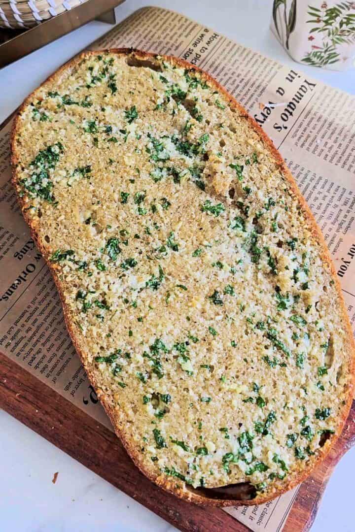 Ciabatta loaf spread with garlic Parmesan butter before baking.