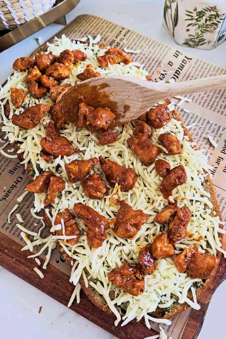 Ciabatta topped with shredded mozzarella and buffalo chicken.