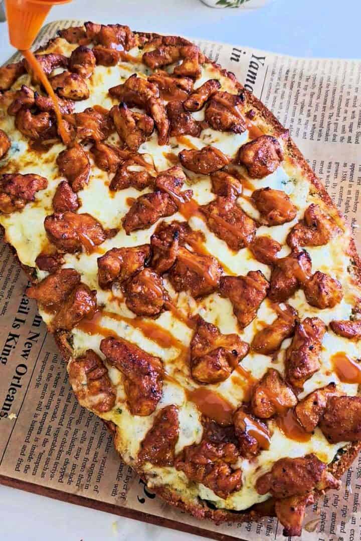 Buffalo chicken garlic bread topped with melted mozzarella and drizzled with buffalo sauce.