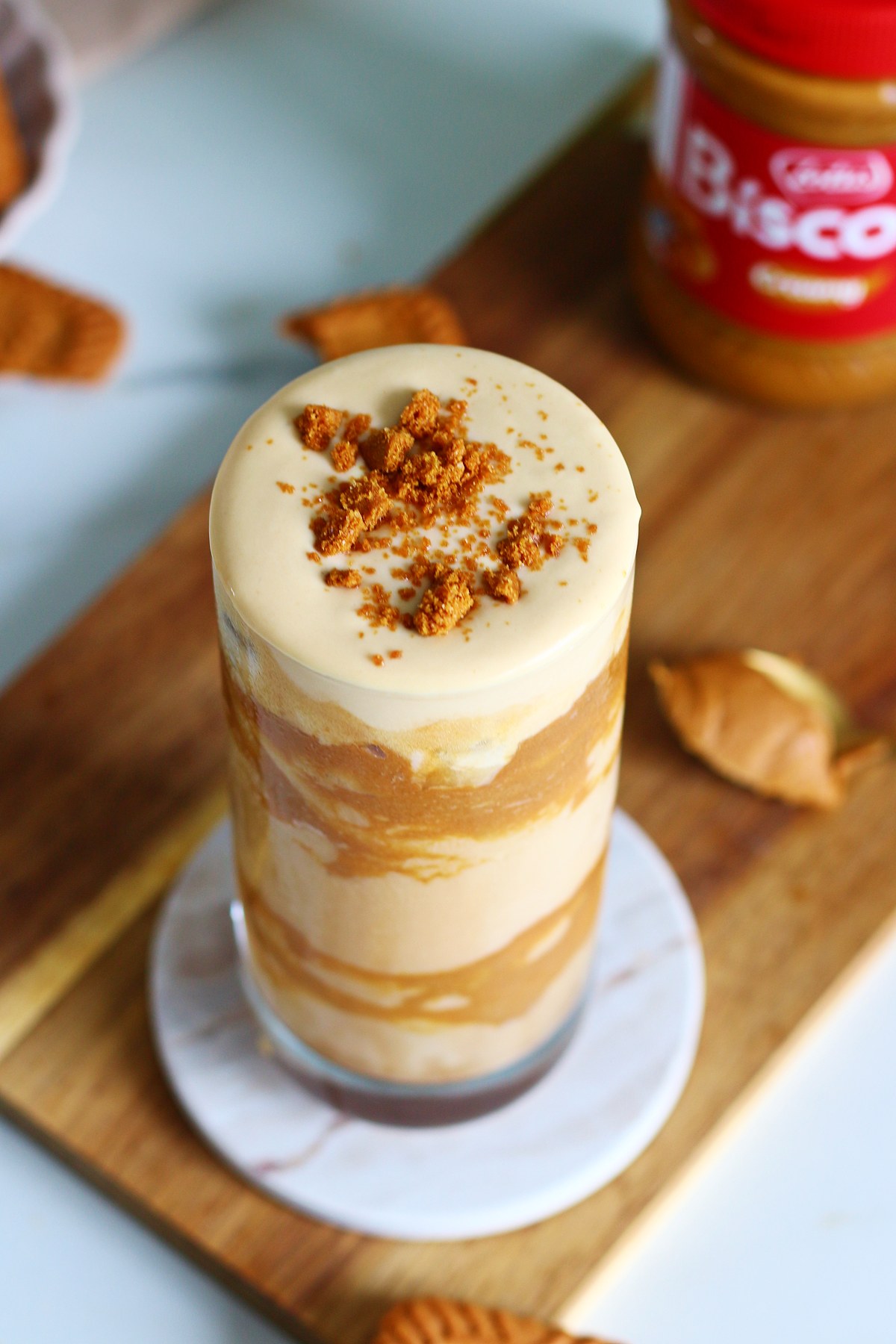 Close up overhead view of iced Biscoff latte cold foam topped with crushed Biscoff cookie crumble.