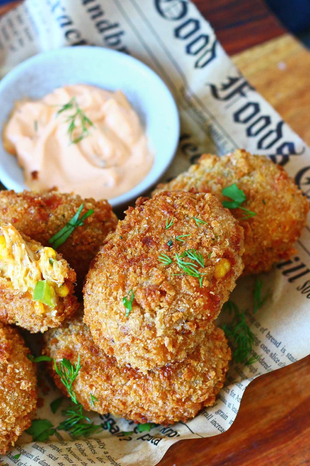 Cheesy chicken croquettes with a creamy dipping sauce on the side.